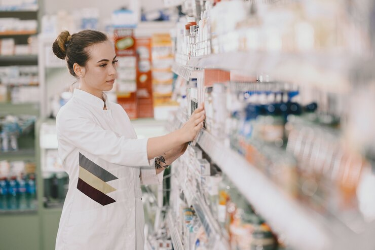 A pharmacist checking & verifying medicines from a stack full of pharma products. - By Smotec Pharmaceuticals (PCD Pharma Company in Arunachal Pradesh) https://smotecpharma.com/